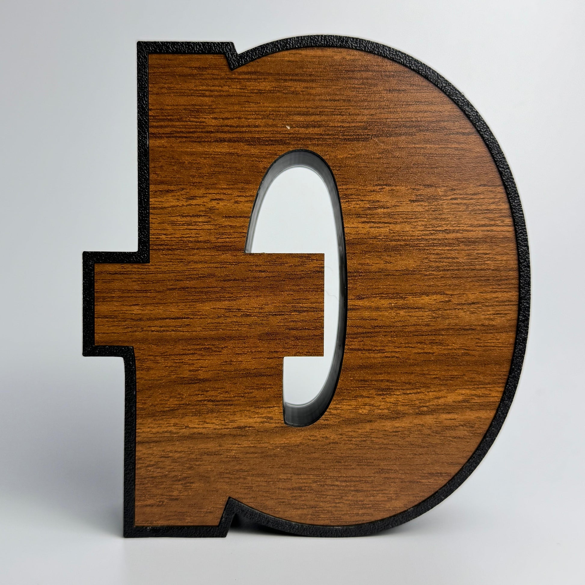 Wooden letter 'D' on a white background