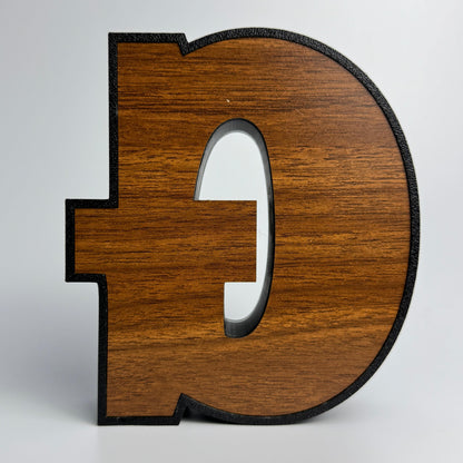 Wooden letter 'D' on a white background