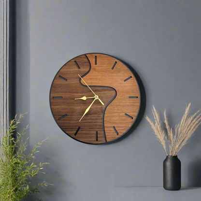 Wooden wall clock with artistic design on a gray wall with decorative elements.