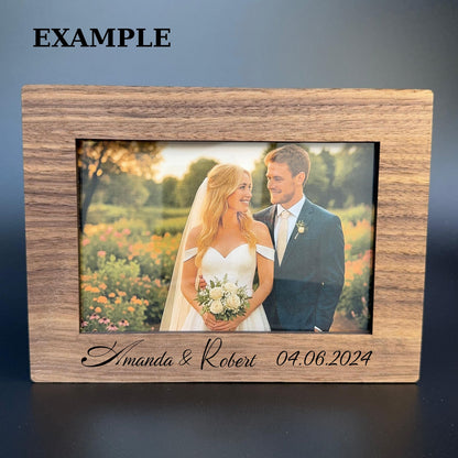 Wooden photo frame with engraved names and date, containing a wedding photo of a couple.