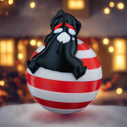 Side view of the Sleeping Dog ornament hanging on a Christmas tree